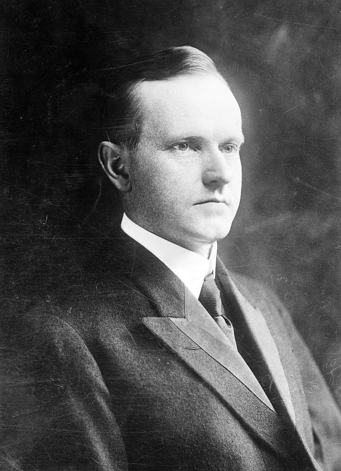 Three-quarters view of a white man in a suit from head and shoulders up.