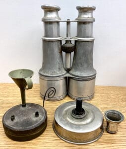 Metal Binoculars And Two Small Oil Lamps
