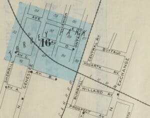 A map showing the crossing of two railroad lines and several streets, including Avenue B.