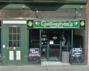 The entrancd to a bar with a green doorframe and a sign saying For the Irish in all of us, Gallaghers Irish Pub.