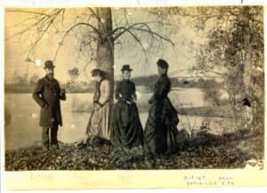 a man and three women along side water