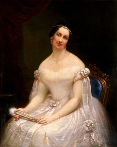 Portrait of woman in a white gown sitting in a chair and holding a fan