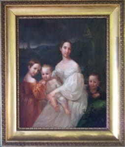 Portrait of woman surrounded by three children.