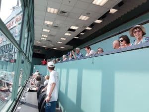 People standing and seating in the press box at Fenway Box