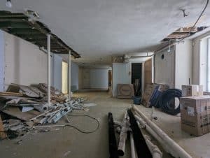 Demolition in progress in the exhibit space outside the Research Room. Lights and pipes have been removed from the ceiling