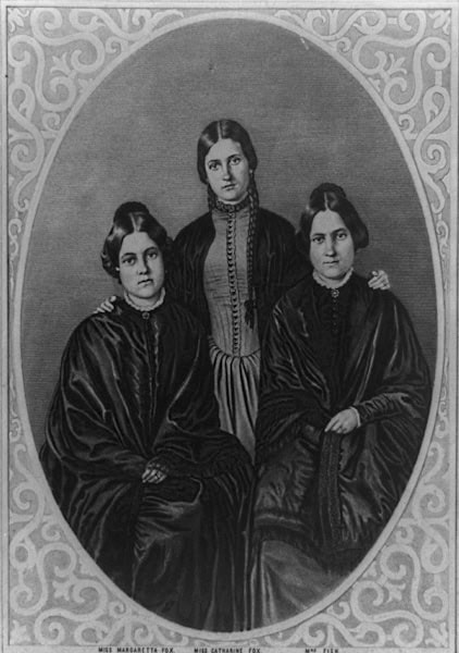 An engraving of three young women in old-fashioned dress.