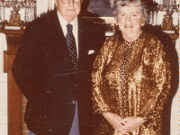 George and Marjorie Hucker standing in front of a painting of George