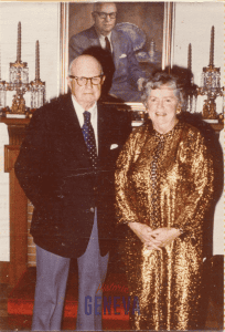 George and Marjorie Hucker standing in front of a painting of George