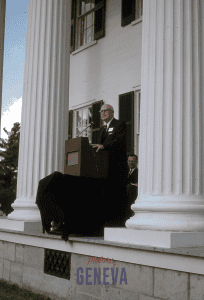 Dr. George Hucker standing behind a podium on the front porch of Rose Hill.