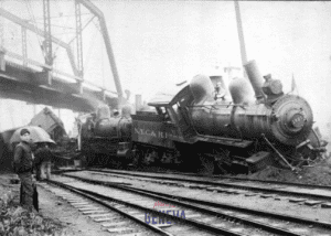 A NYC & HR train engine crashed off tracks under a railroad bridge.