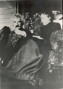 Samuel and Livy Clemens sitting on a porch