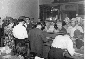 A crowd of men standing in line to apply for work at Seneca Army Depot and Sampson Naval Training Station