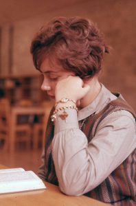 Female student sitting at a desk reading