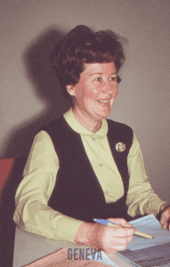 colored photo of a woman sitting at a desk