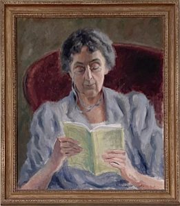 Painting of an elderly woman sitting in a red chair reading a magazine.